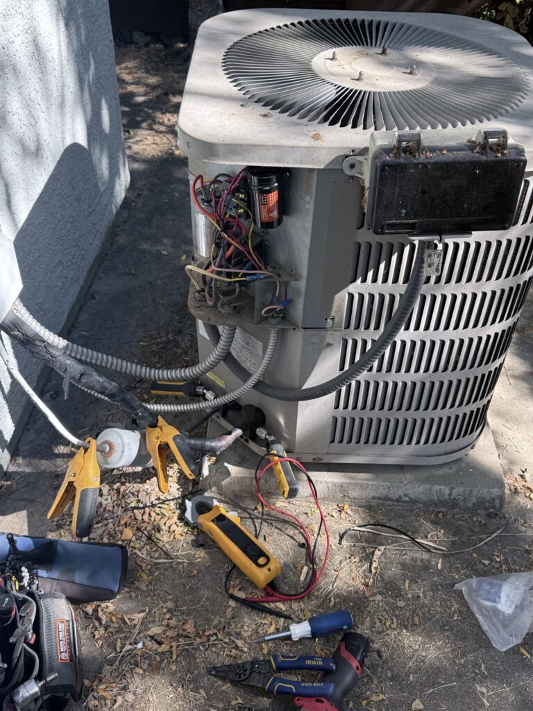 Fusion HVAC technician repairing an outdoor air conditioner in Sacramento