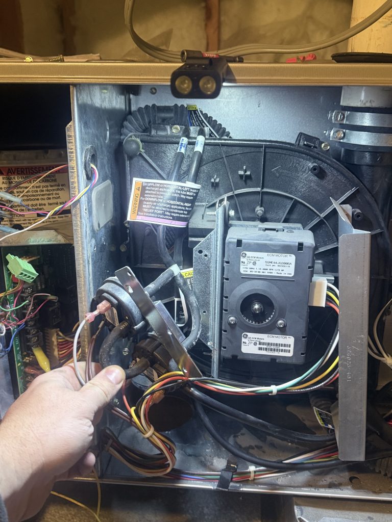 Furnace inducer assembly and pressure switches during a repair in Lahontan, Truckee
