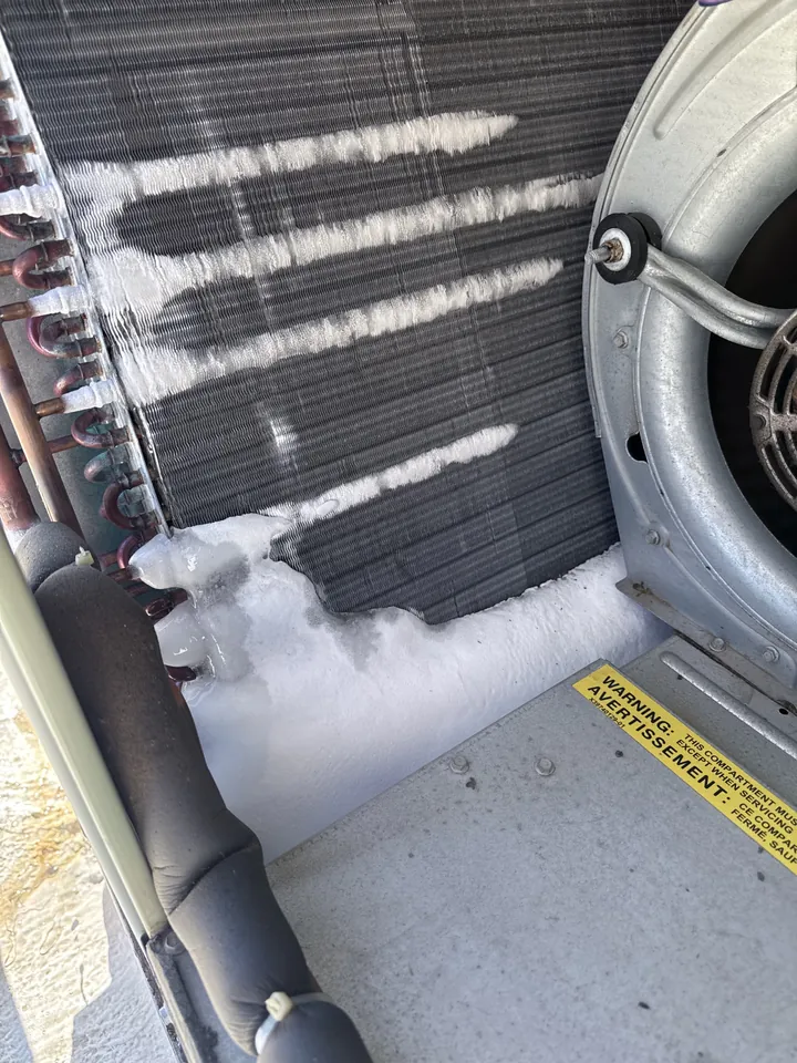 Ice covering sections of the evaporator coil inside an R-22 rooftop package unit in Loomis, California
