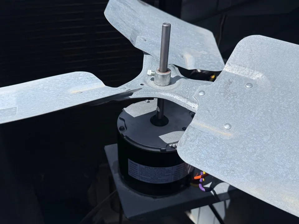 Replacement condenser fan motor and fan blade installed inside the rooftop AC unit