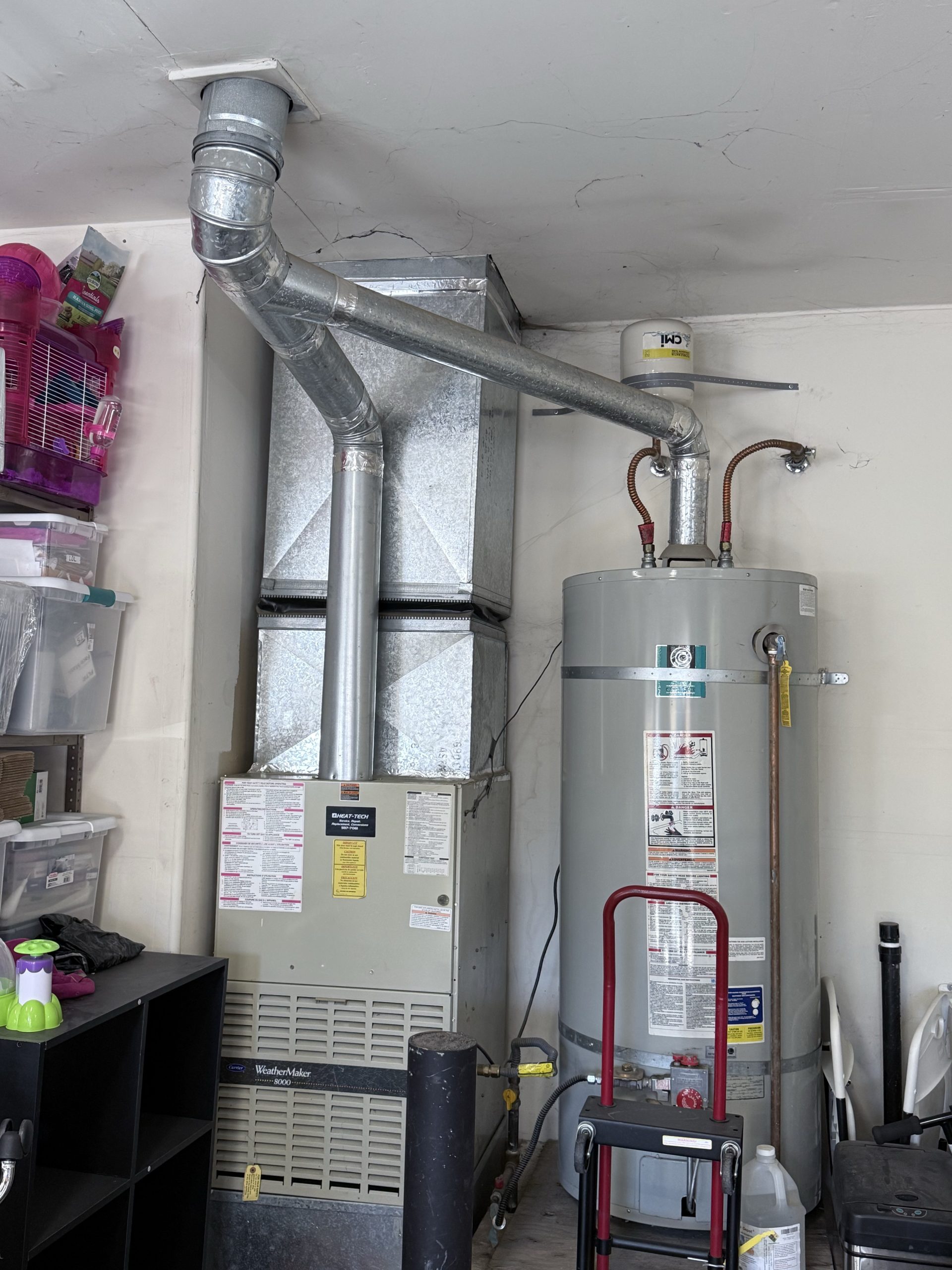 Old gas furnace and gas water heater before replacement in Glenshire, Truckee