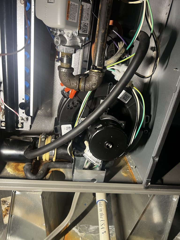 Replacement inducer motor installed inside the furnace during a Newcastle, CA heating repair