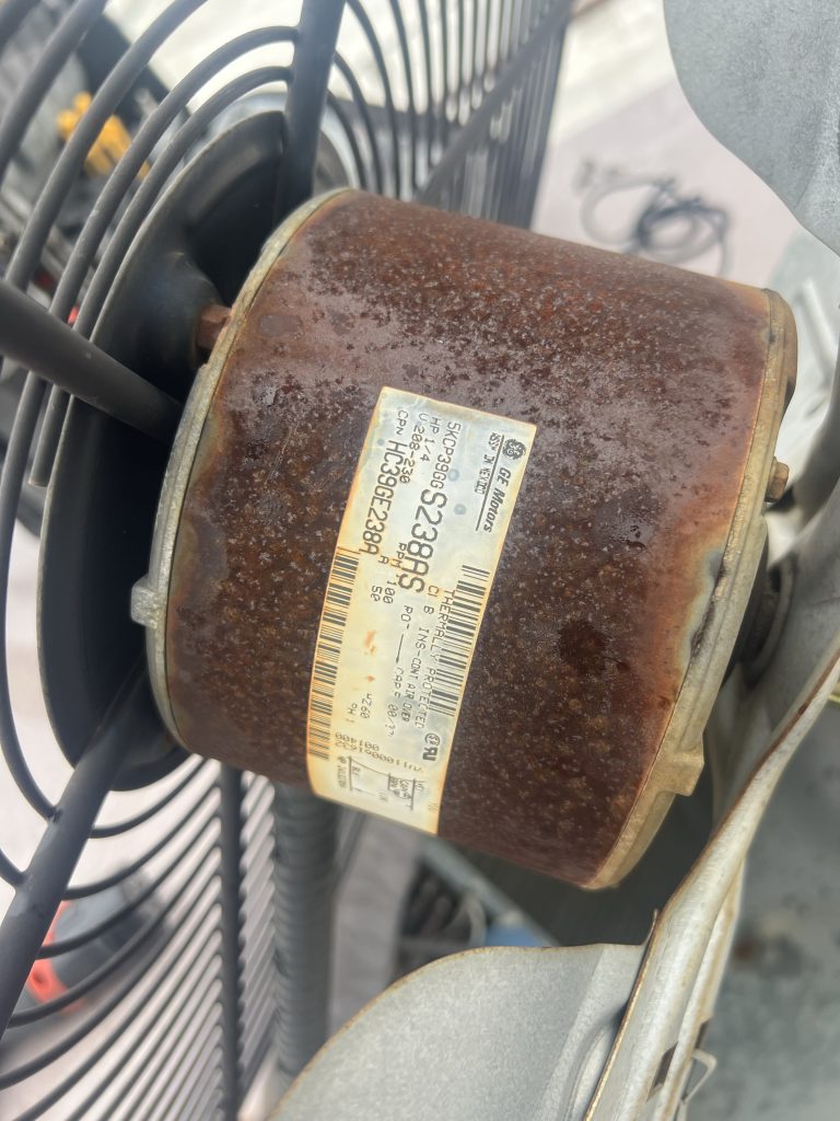 Original condenser fan motor and fan blade before replacement during an AC repair in Penryn, CA