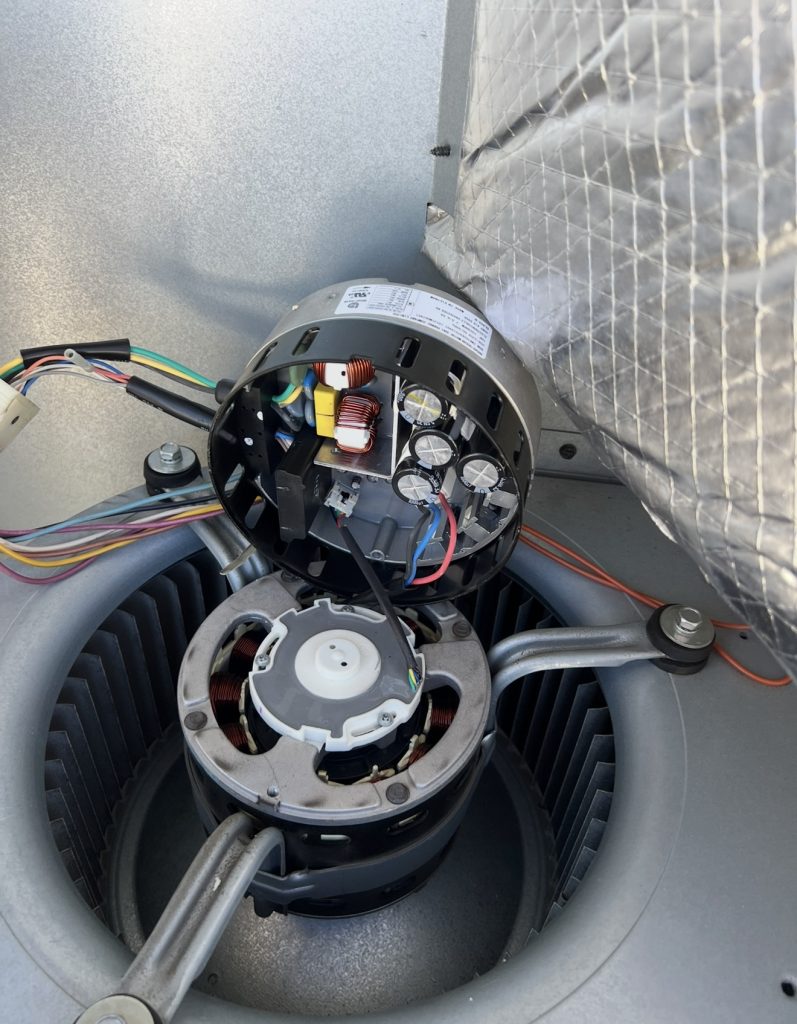 Blower motor with its electronic module exposed during a heater repair in Truckee, CA