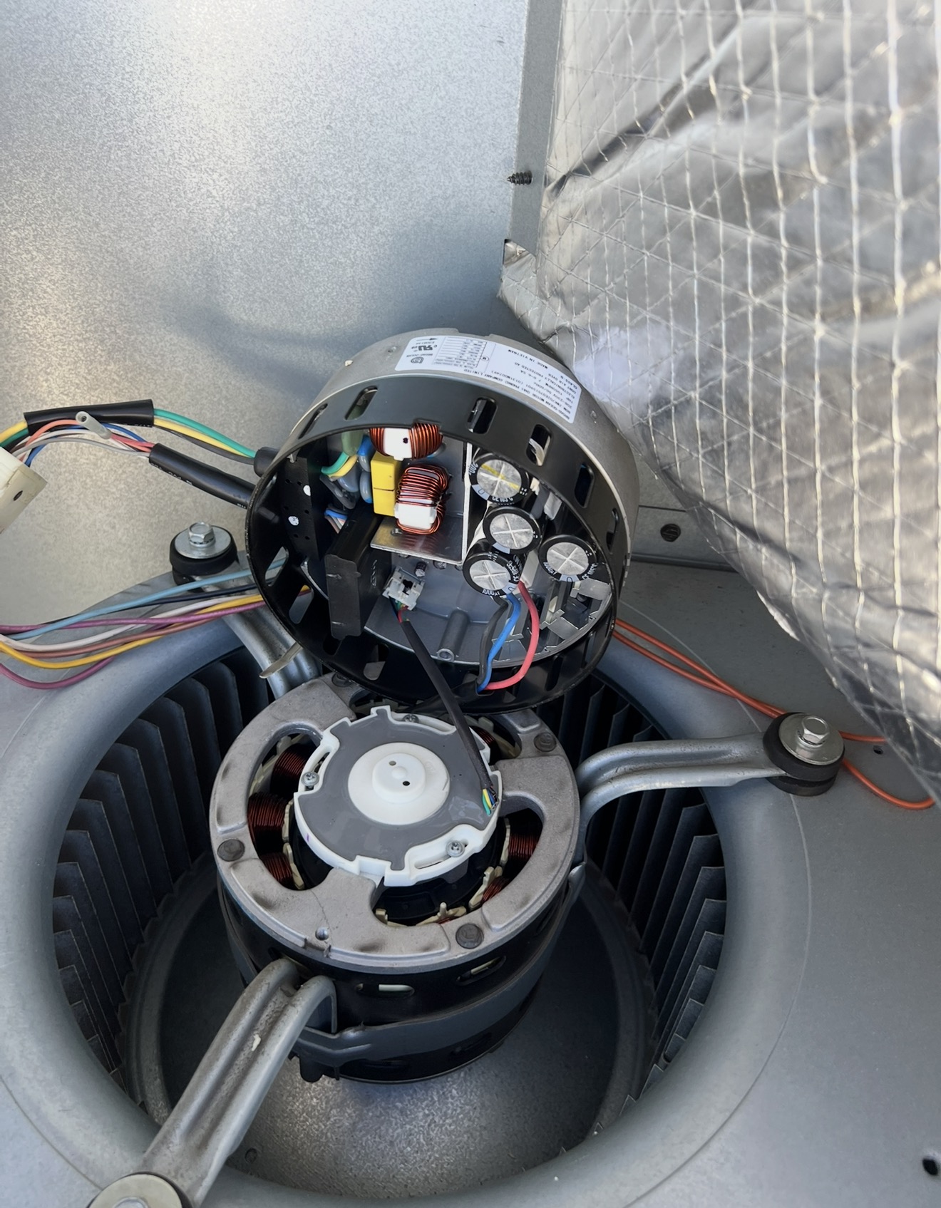 Blower motor with its electronic module exposed during a heater repair in Truckee, CA